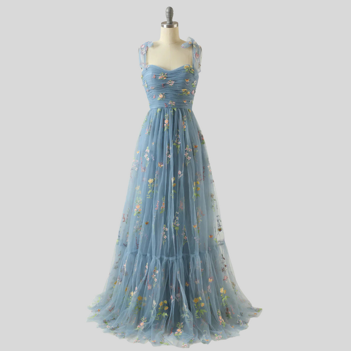 Formal women's party dress: elegant embroidered tulle ball gown with an off-shoulder design.