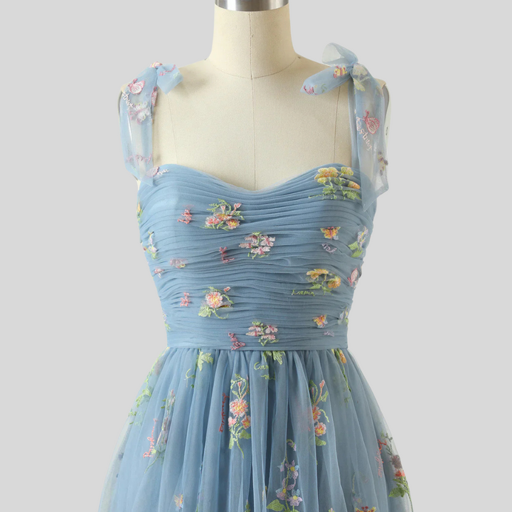 Statement women's formal gown: embroidered tulle, off-shoulder, perfect for special events.