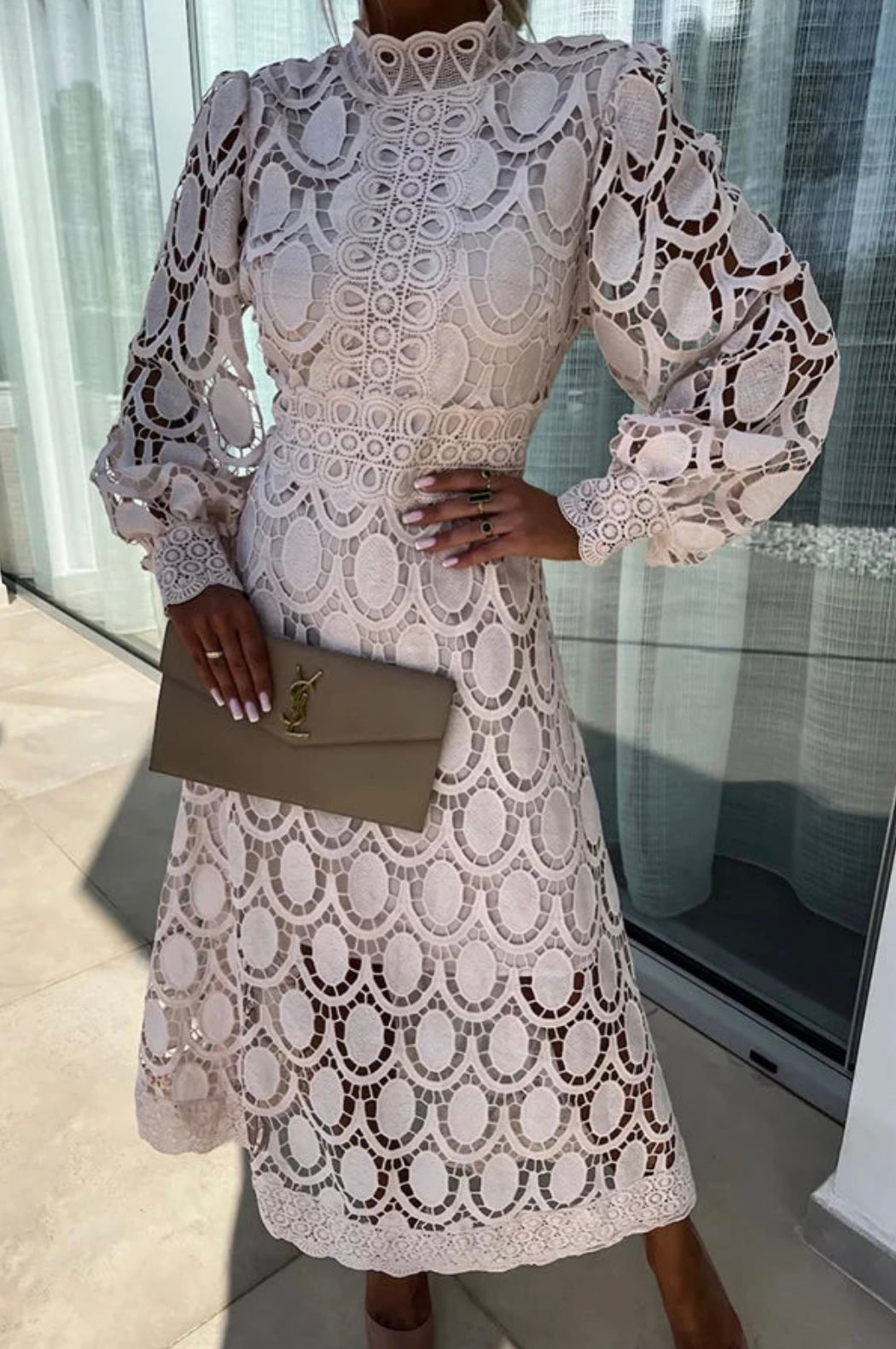Stylish openwork midi dress for women, featuring a high neck and long sleeves. Ideal for evening events.