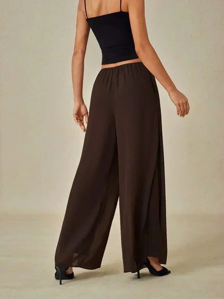 Flowy women's wide leg trousers, showcasing a unique overlay for an elegant and layered look.