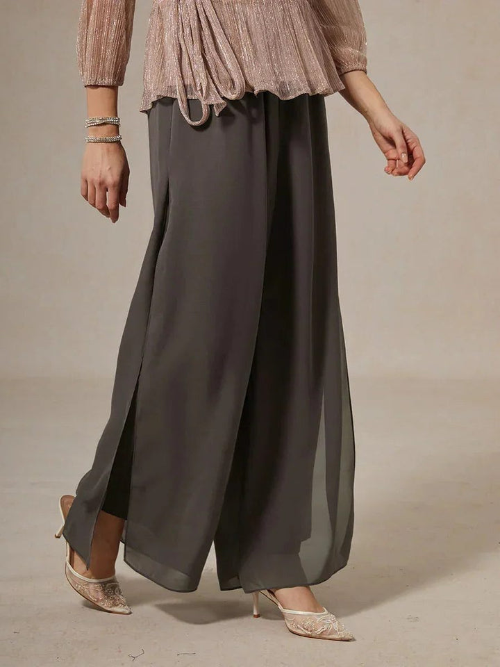 Women's fashionable wide leg trousers with a flowy overlay, suitable for diverse elegant events.