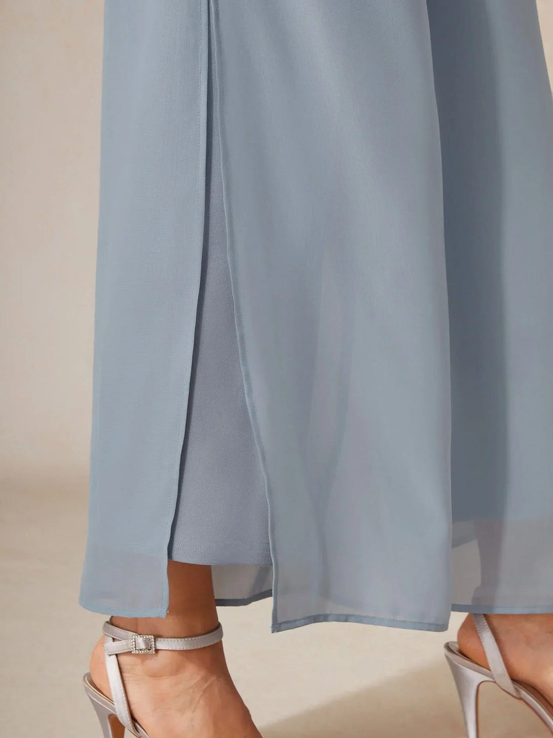 Elegant women's wide leg trousers with a flowy overlay, creating a chic and sophisticated appeal.