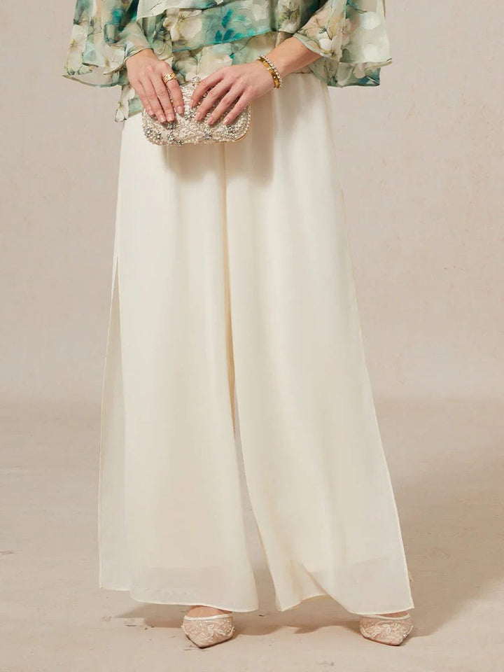 Fashionable women's flowy wide leg trousers with a layered overlay for an elegant silhouette.