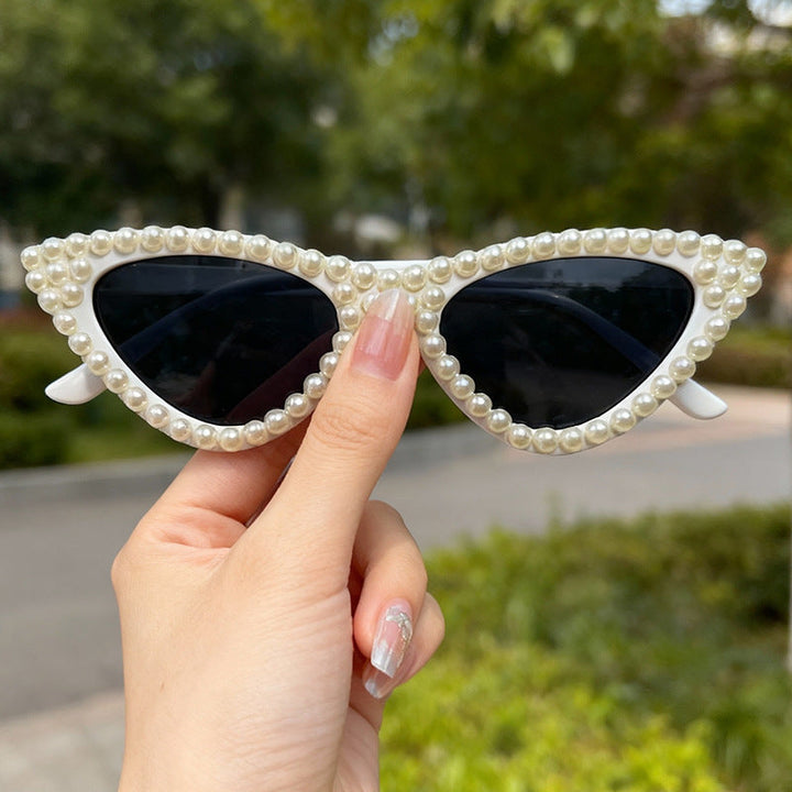 Women's pearl trim cat eye sunglasses, a unique and elegant accessory with UV safeguard.