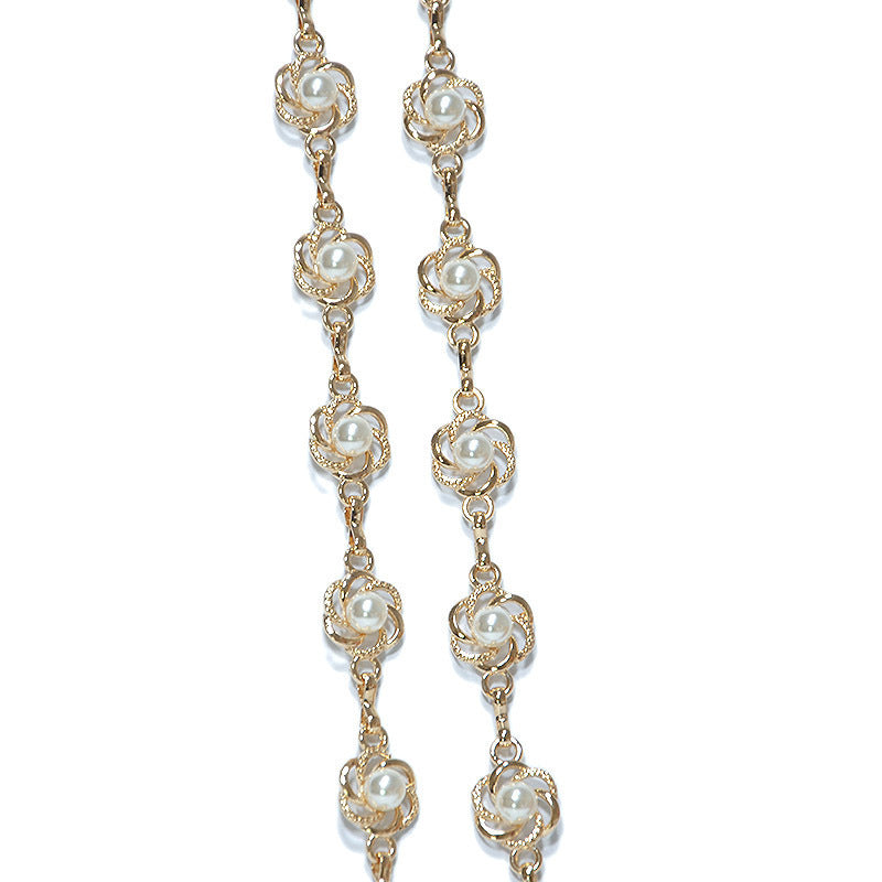 Versatile women's gold chain belt featuring delicate white pearls, suitable for various outfits & occasions. Waist accent.