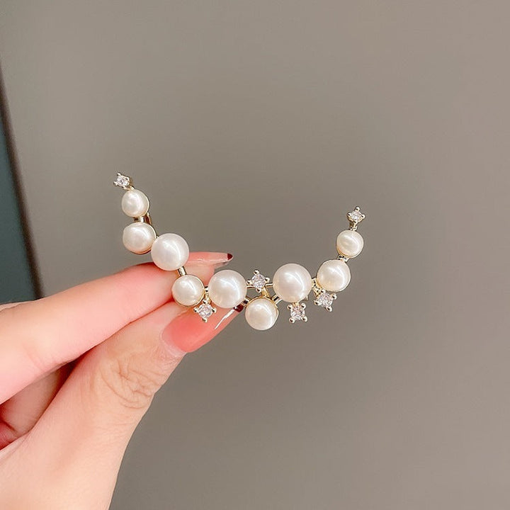 Elegant women's pearl drop earrings, a timeless piece of fashion jewelry for any occasion.