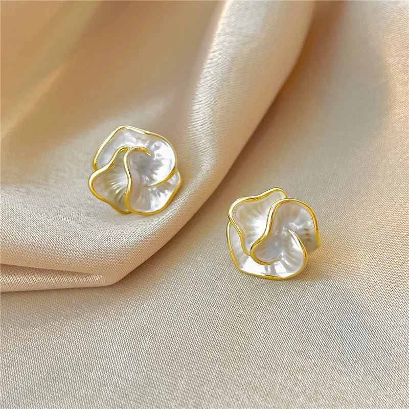 Fashionable women's pearl flower earrings with delicate dangle design, perfect elegant jewelry.