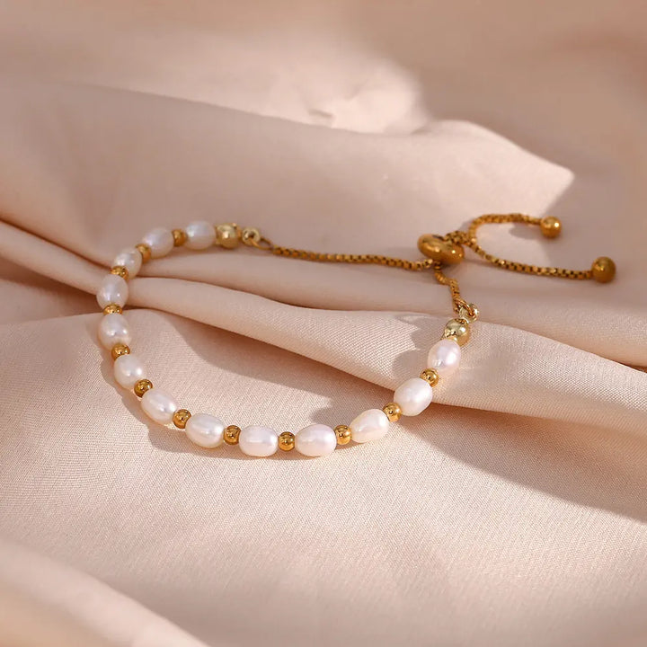 Elegant women's pearl & gold bracelet. Classic jewelry accessory for fashion-forward women.