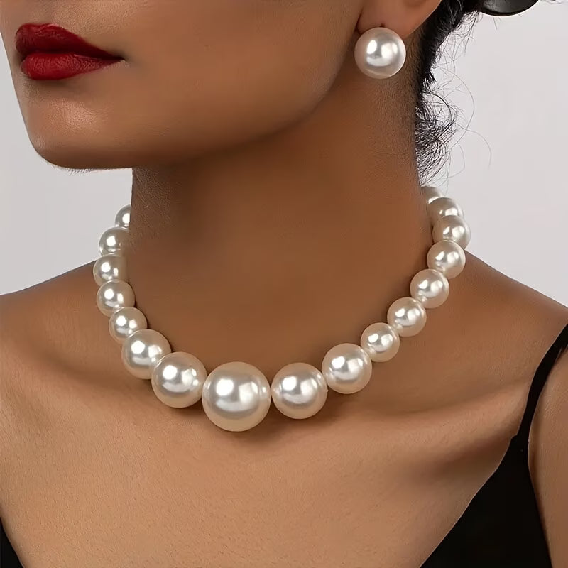 Elegant women's pearl necklace and matching drop earrings set. Timeless classic jewelry accessory for special occasions.