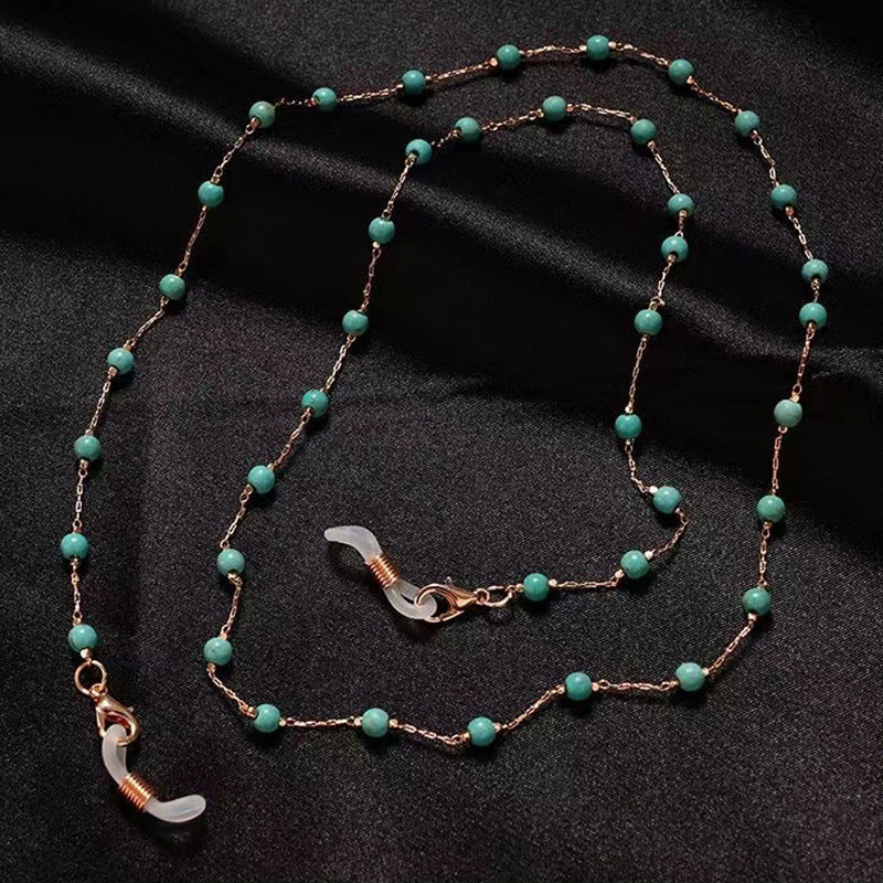 Elegant women's pearl necklace with intricate filigree pendant, a delicate fashion accessory for her.
