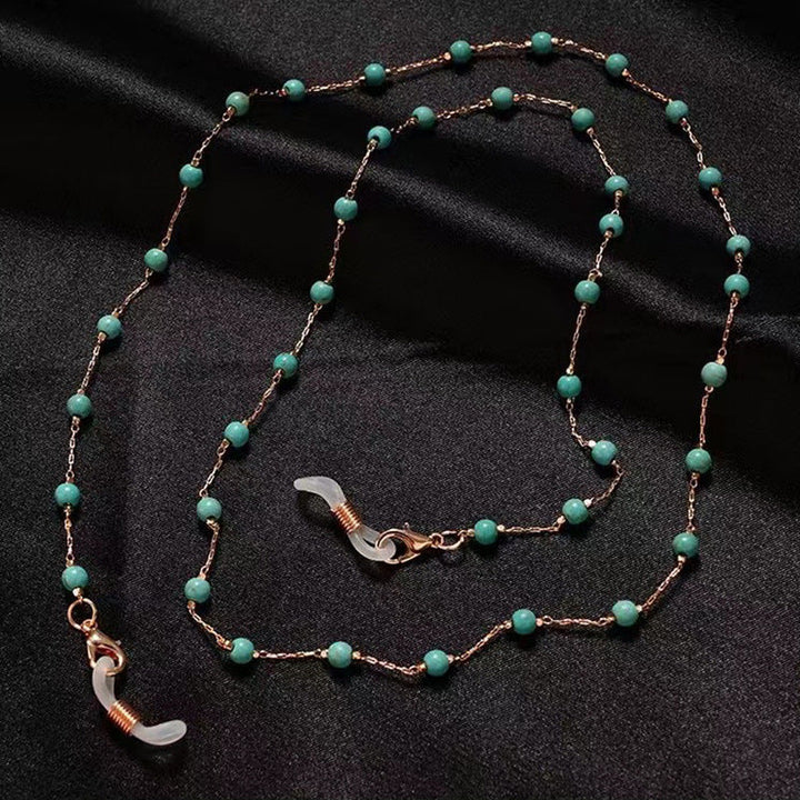 Elegant women's pearl necklace with intricate filigree pendant, a delicate fashion accessory for her.