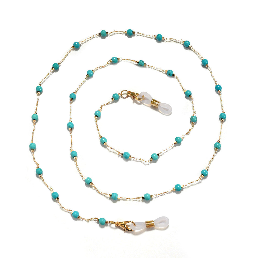 Women's elegant pearl necklace featuring a detailed filigree pendant, a sophisticated fashion accessory.