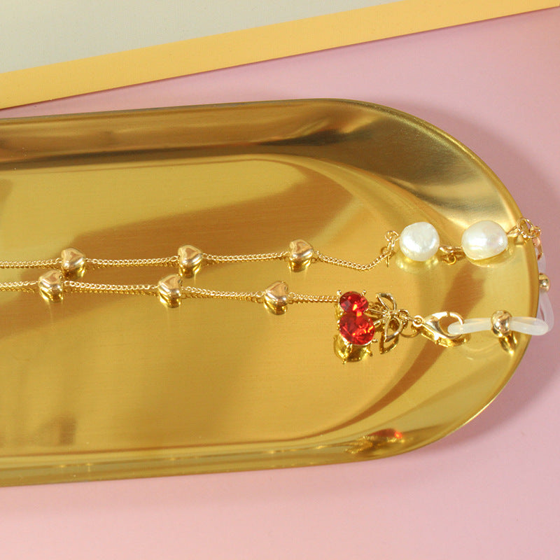 Women's elegant pearl ribbon with delicate silver accents, a chic fashion jewelry piece for special events.