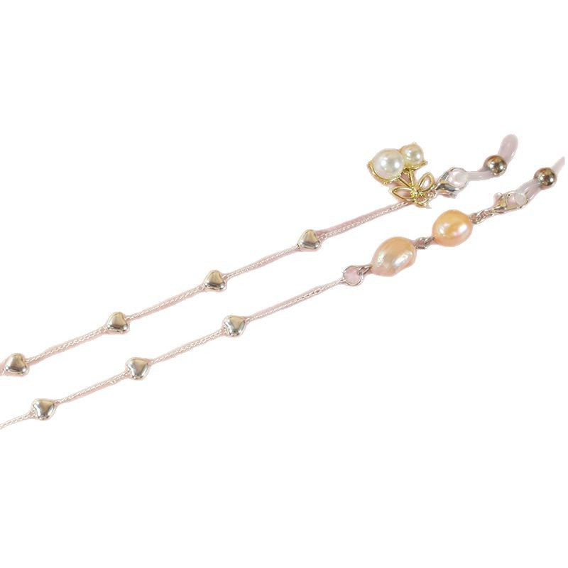 Stunning pearl & gold accented ribbon necklace for women, an elegant and glamorous accessory for everyday fashion.