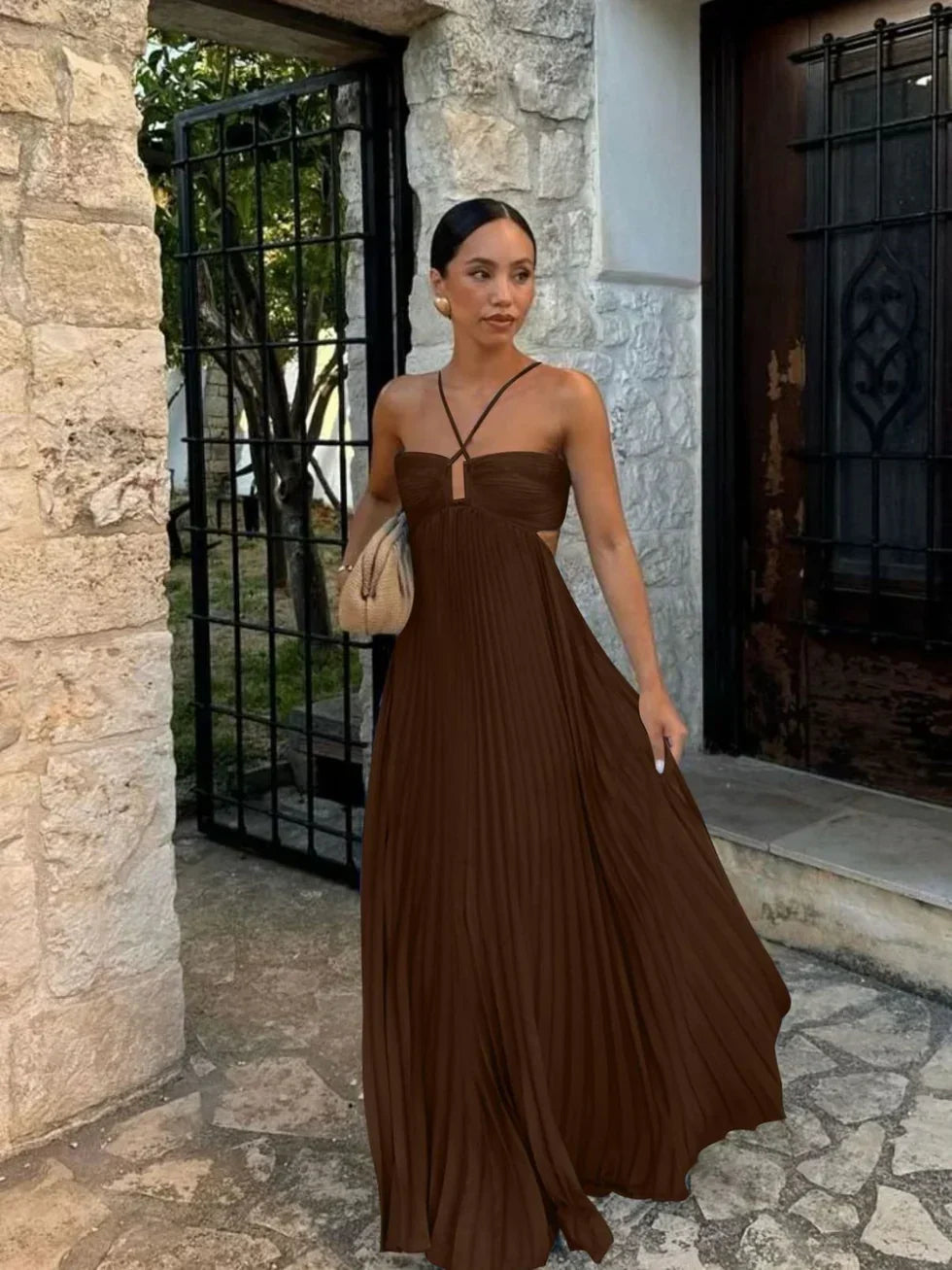 Pleated high-waist maxi dress for women featuring a flattering halter neck and trendy side cut-outs. Occasion wear.