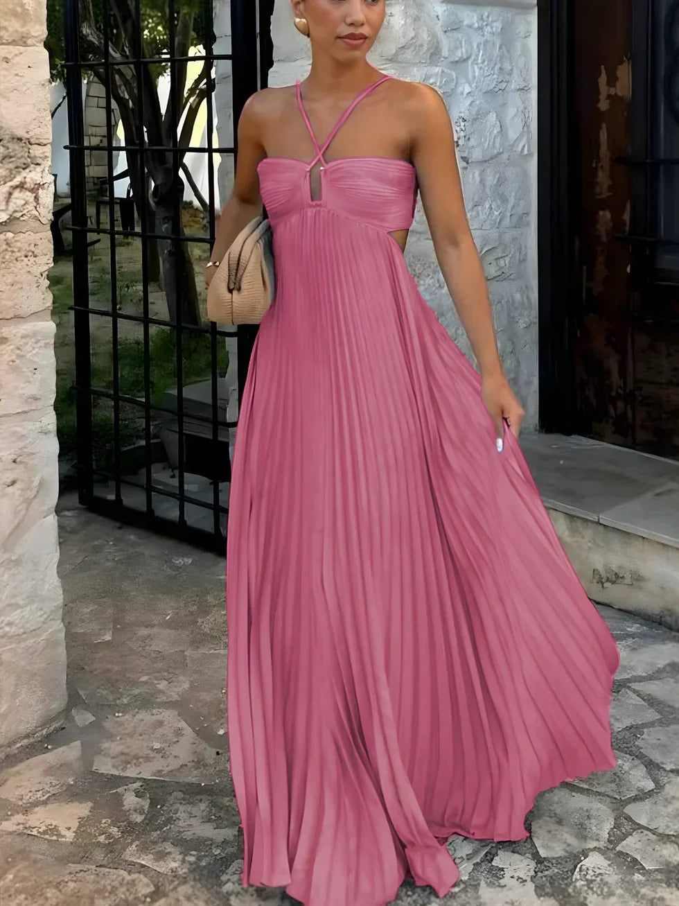 Women's long pleated halter dress with unique side cut-outs. Ideal elegant summer fashion or evening party wear.