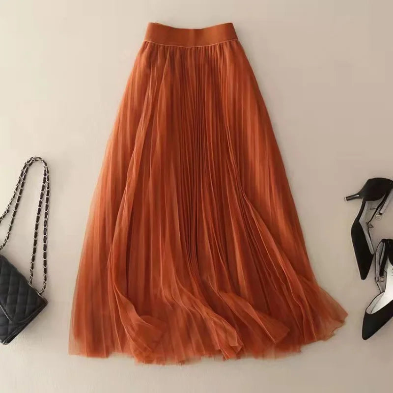 Vibrant orange pleated high-waisted A-line midi skirt for women, a versatile and elegant fashion piece.
