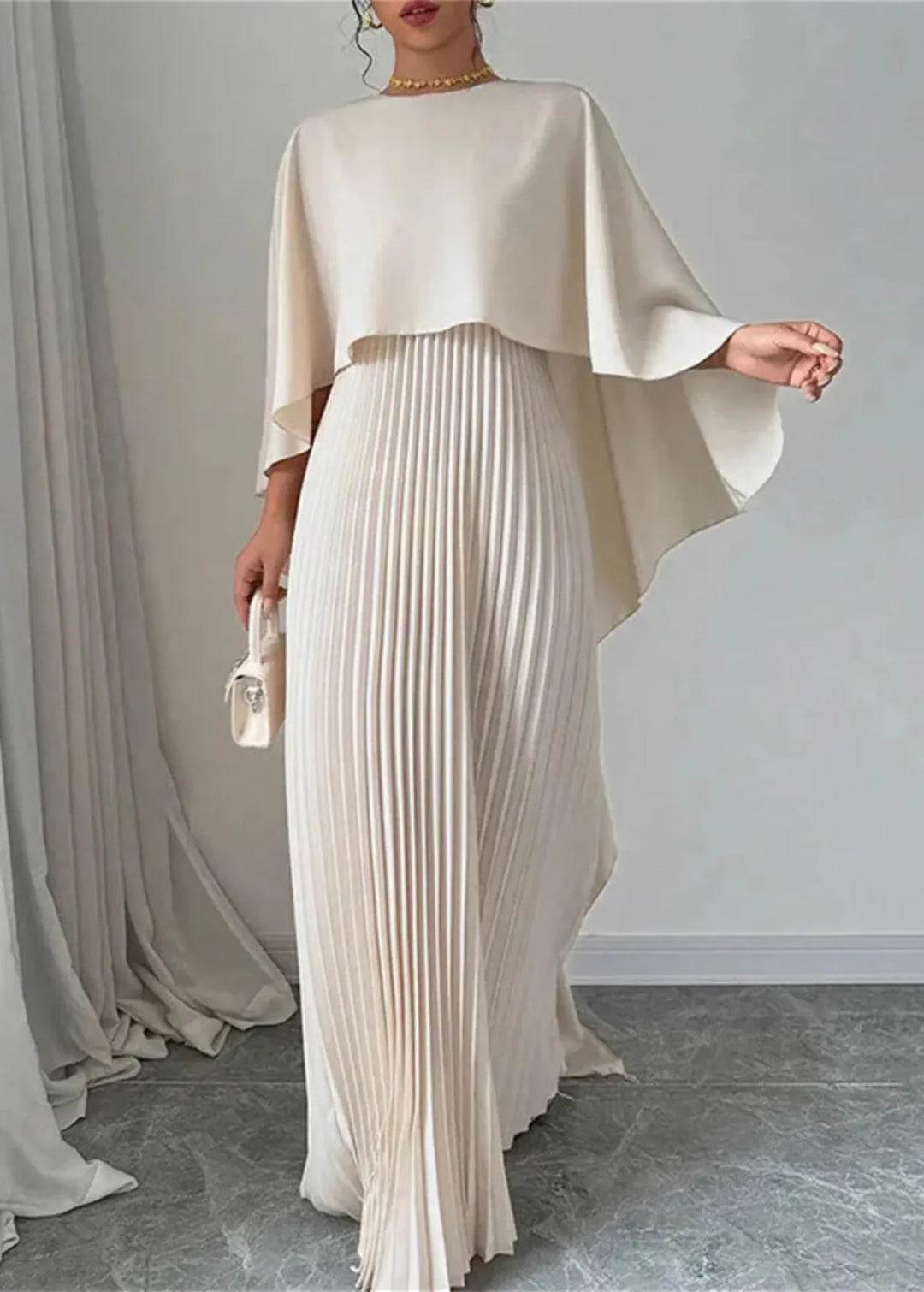 Sophisticated women's formal gown: pleated maxi dress with a stunning flowing cape, ideal for special occasions.