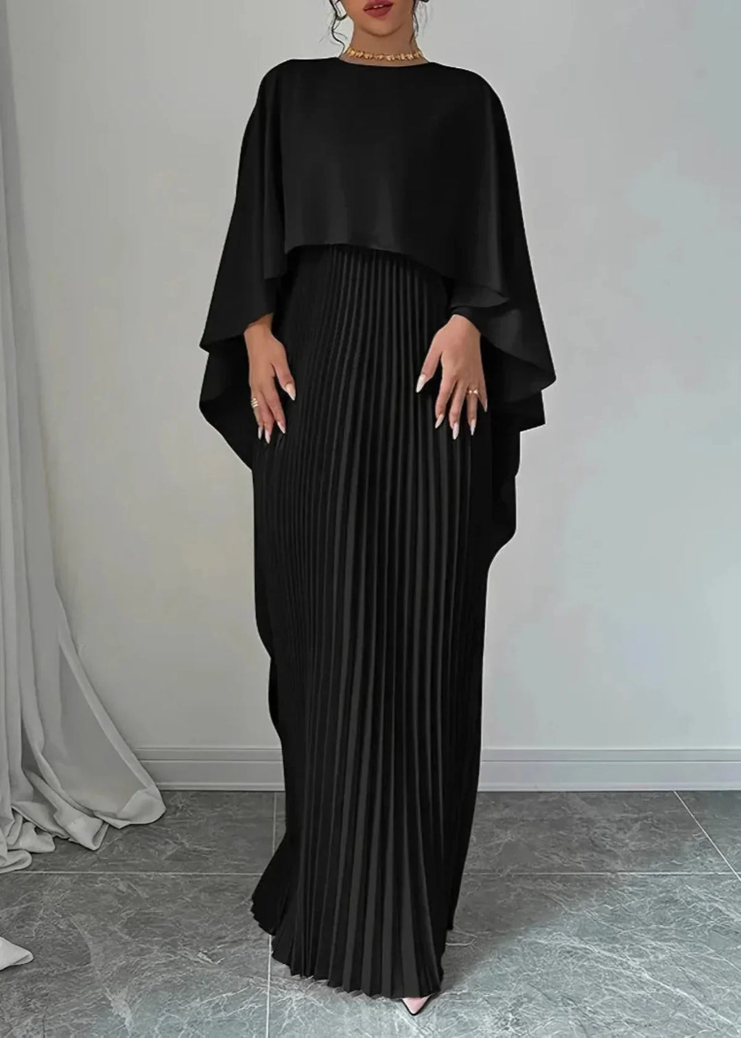 Stunning women's pleated maxi dress with a dramatic flowing cape overlay, a perfect formal gown for any special occasion.