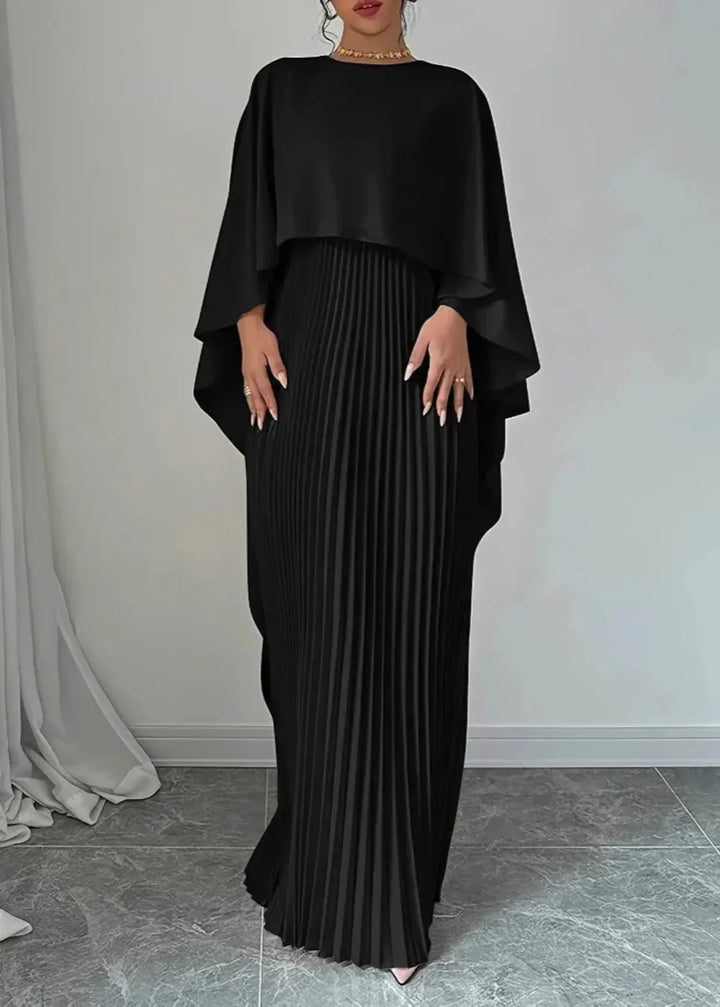 Stunning women's pleated maxi dress with a dramatic flowing cape overlay, a perfect formal gown for any special occasion.