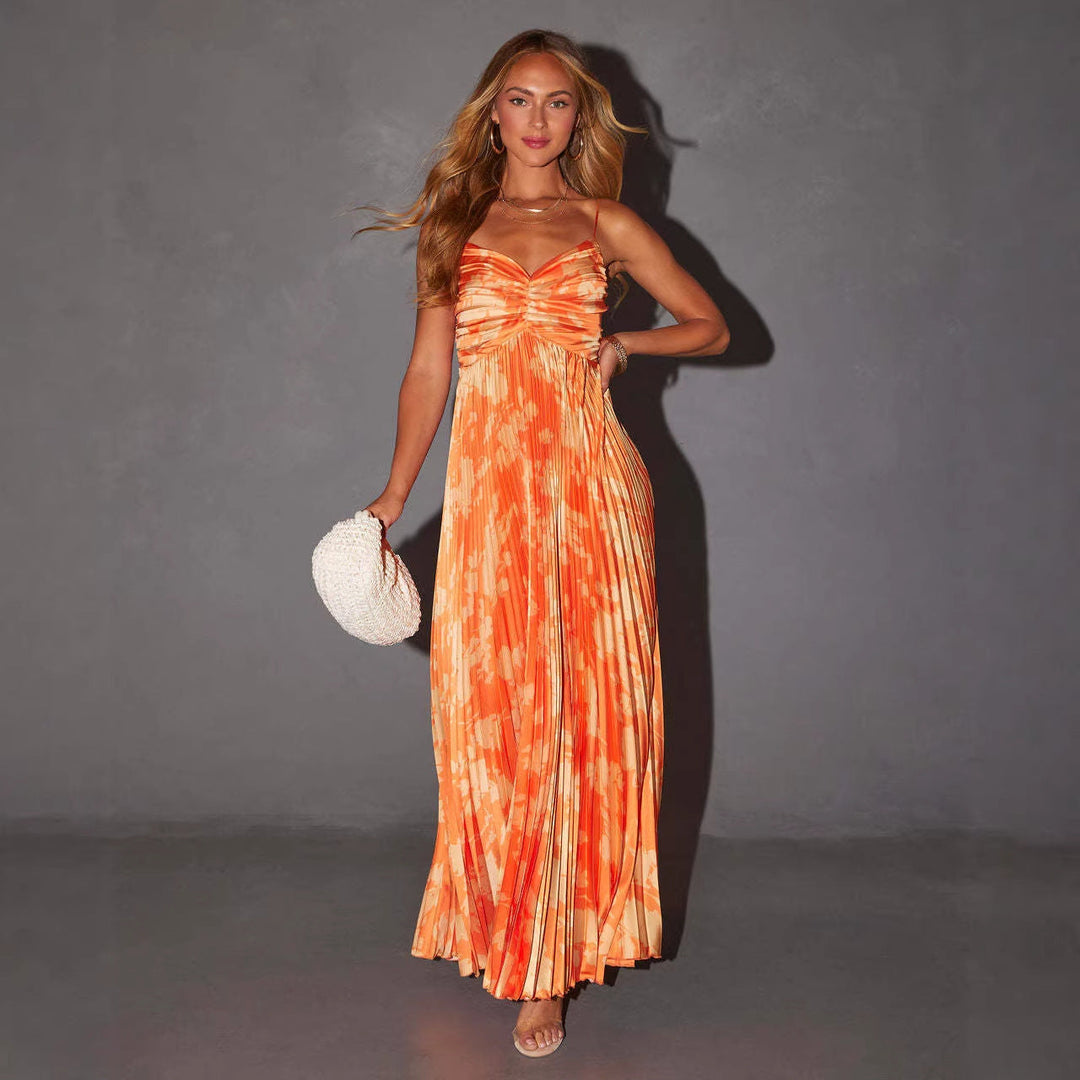Flowy elegant women's pleated maxi dress with a unique blue and orange tie-dye print, perfect for evening wear or special events.