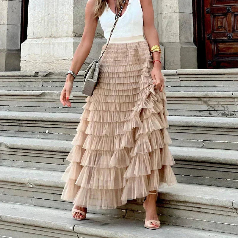 Flowy women's midi skirt, elegant pleated design for versatile casual or dressed-up chic outfits.