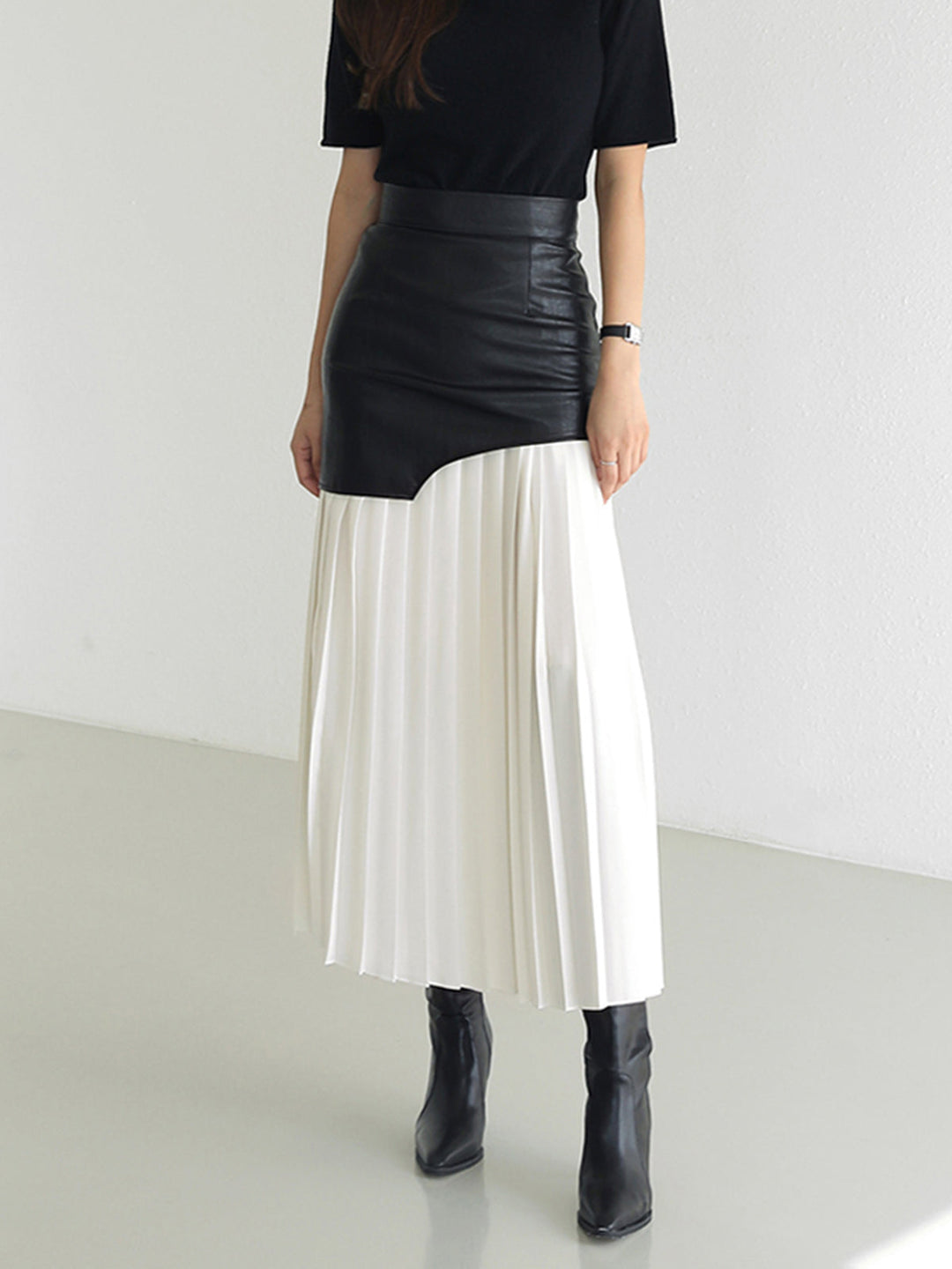 Elegant women's pleated midi skirt with a flattering asymmetrical design. Perfect for modern style.