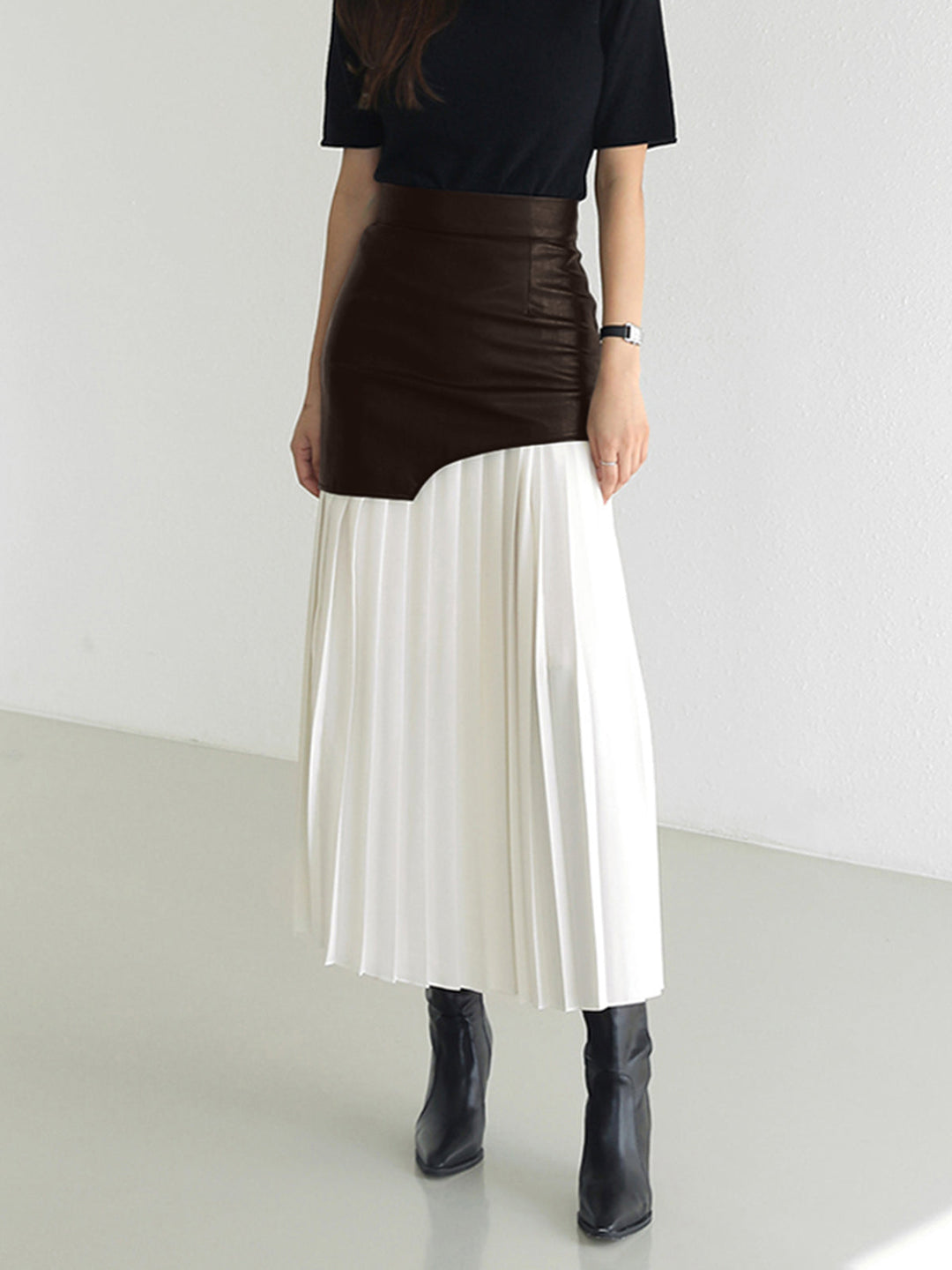 Women's elegant pleated midi skirt in various colors, featuring a flattering asymmetrical design. Modern style.