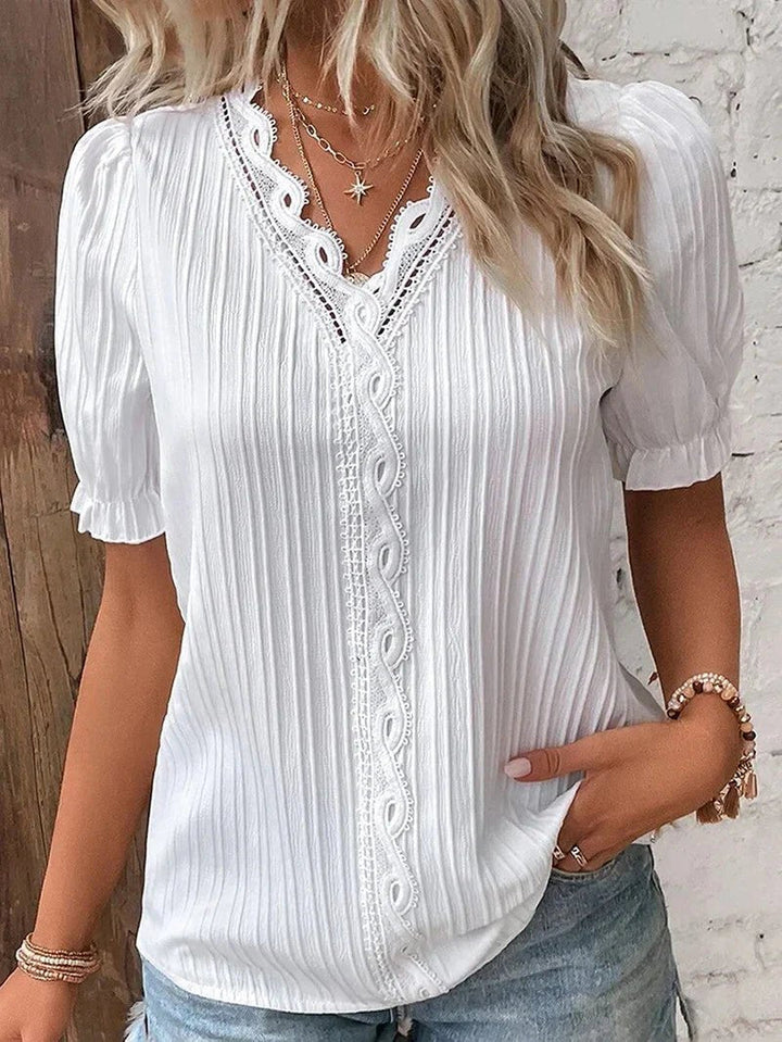 Elegant women's plus size blouse with lace v-neck and short sleeves. Perfect for casual or workwear, comfortable & stylish.