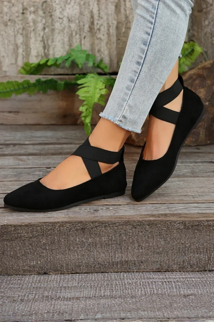 Women's pointed toe ballet flats with ankle strap, offering an elegant and comfortable fit.