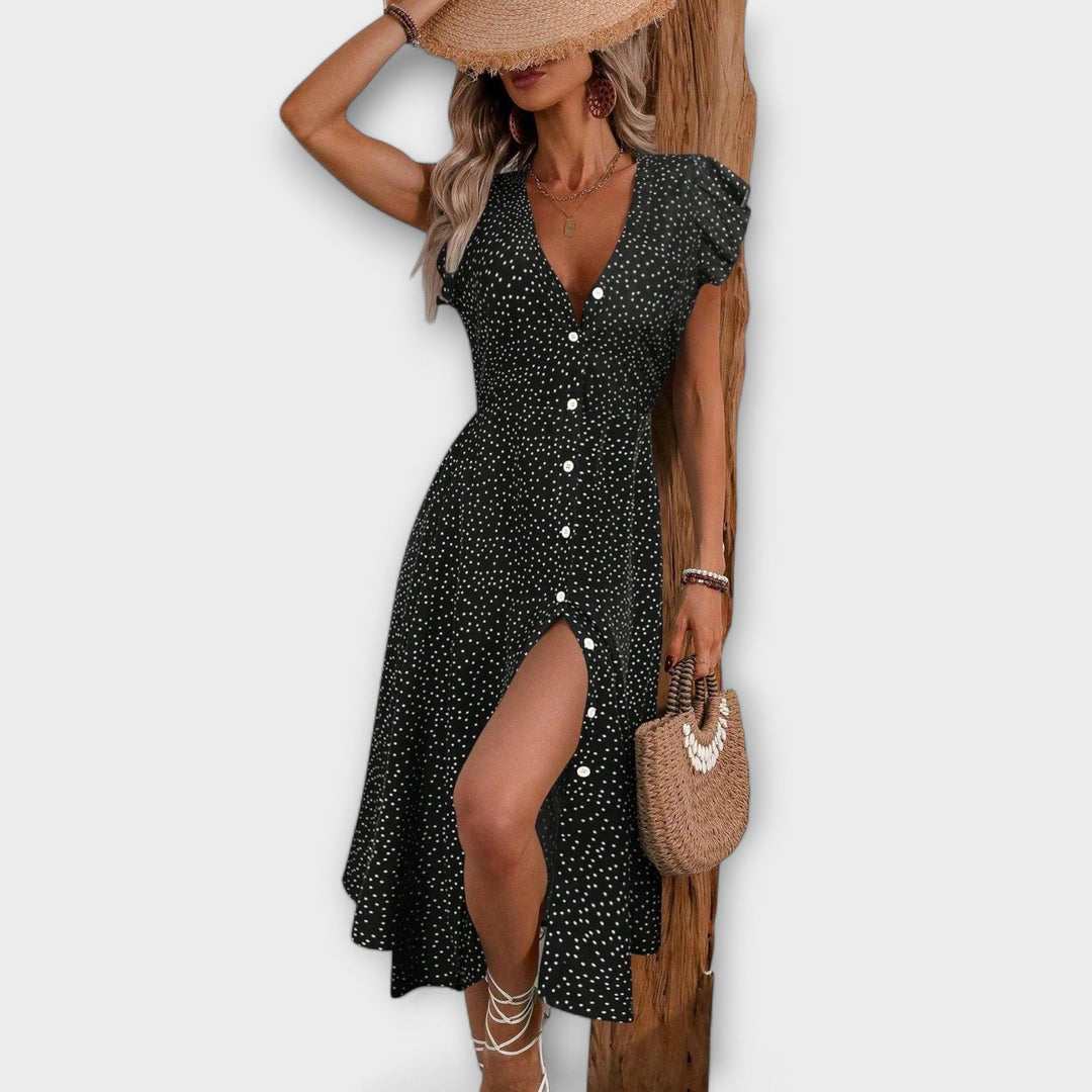 Stylish women's A-line midi dress in polka dots, showing flowy silhouette, ideal for spring/summer elegance.