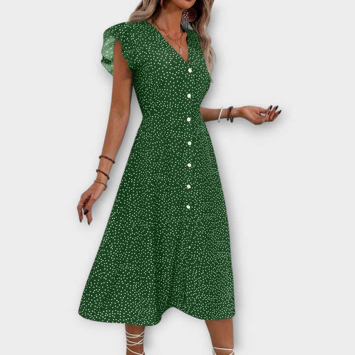 Full length shot of woman in elegant polka dot A-line dress, perfect for casual or party wear.