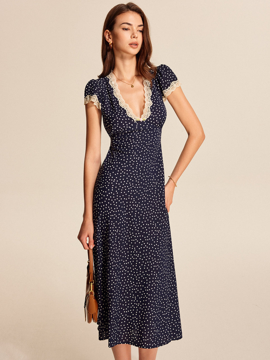Timeless women's polka dot party dress with intricate lace trim details and comfortable cap sleeves.