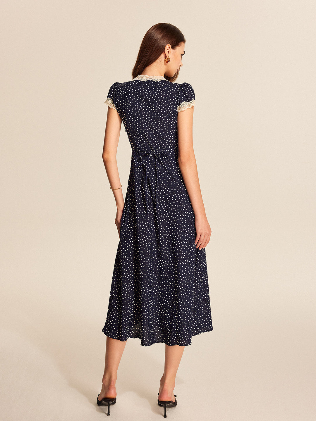 Stylish women's polka dot dress, A-line cut, with a feminine v-neckline and short cap sleeves.