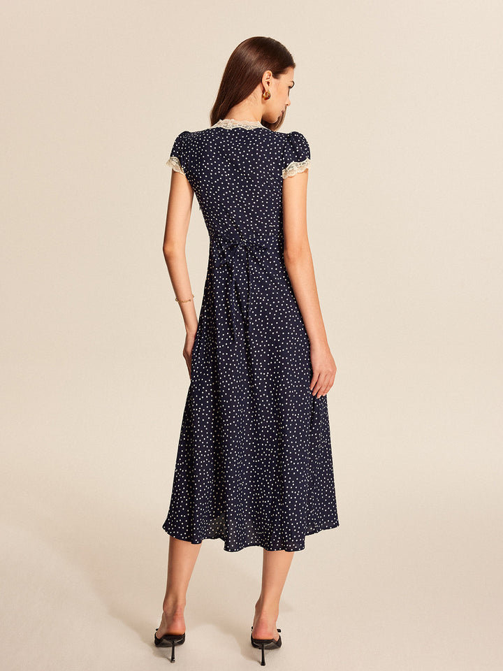 Stylish women's polka dot dress, A-line cut, with a feminine v-neckline and short cap sleeves.