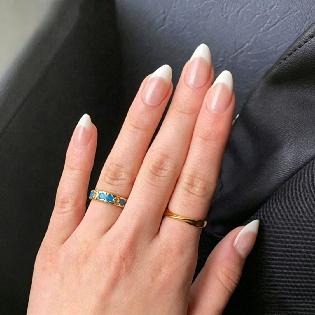 Close-up of elegant white & nude almond press-on nail stickers. Perfect for women's DIY salon manicure.