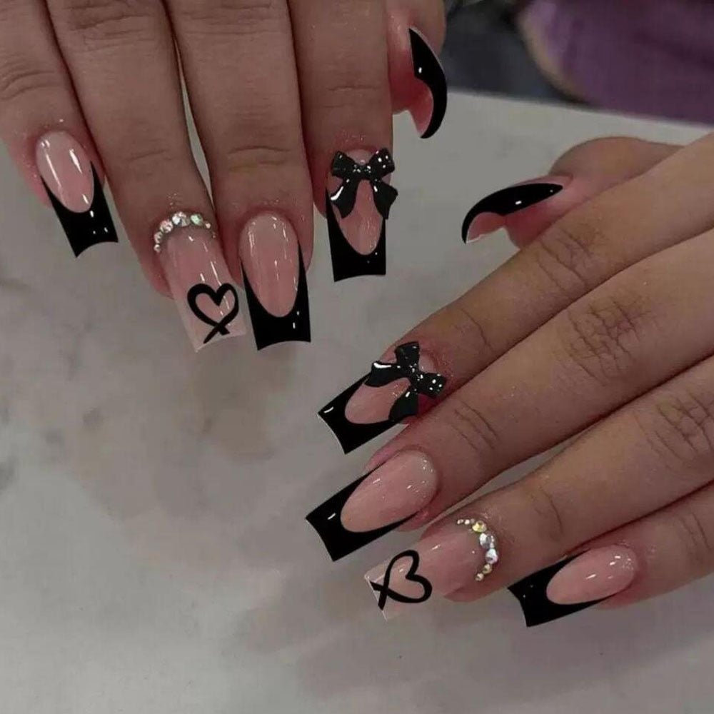 Durable false nails with chic black French tips, adorable bows, and romantic heart designs.