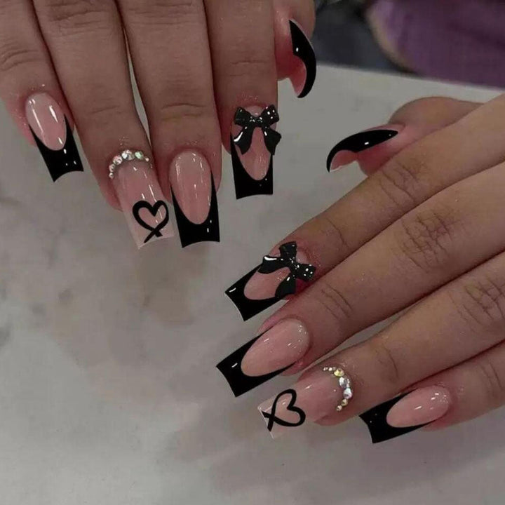 Durable false nails with chic black French tips, adorable bows, and romantic heart designs.