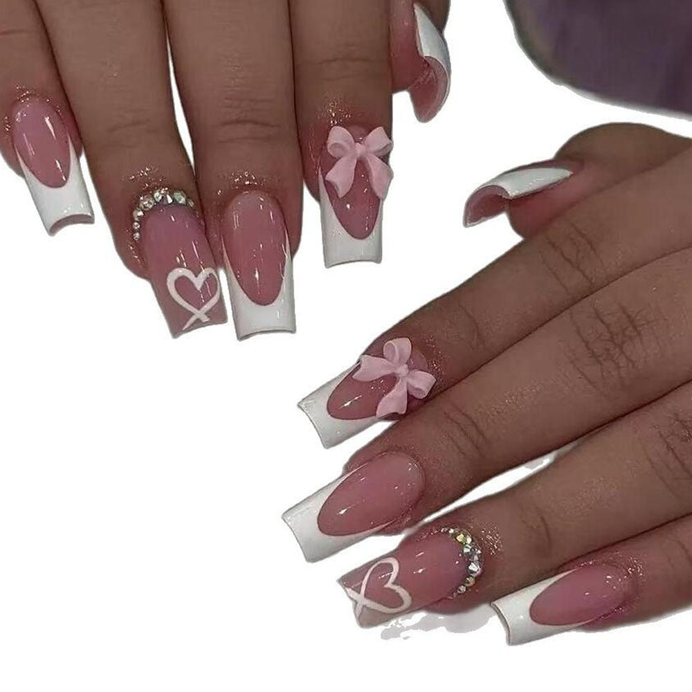 Women's elegant press-on nails, perfect for a quick, fashionable manicure with black tips & hearts.