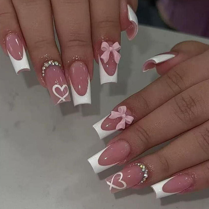 Get an instant elegant manicure with these durable black tip press-on nails adorned with bows & hearts.