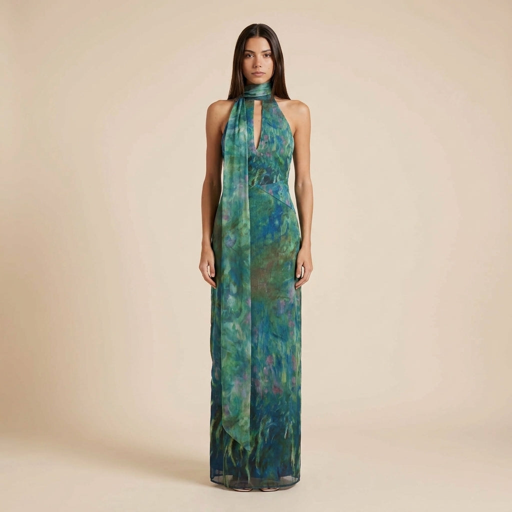 Elegant women's printed halter maxi dress with an open back, perfect for special occasions or vacation wear.