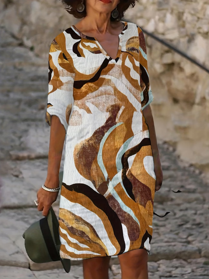 Stylish women's knee-length summer dress featuring a vibrant elegant print, ideal for warm weather.