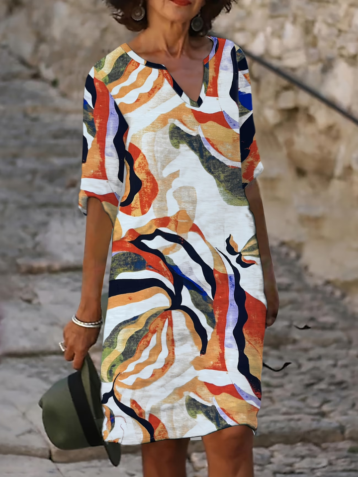 Relaxed fit women's elegant summer dress, featuring a colorful print and flowy midi length, ideal for casual outings.