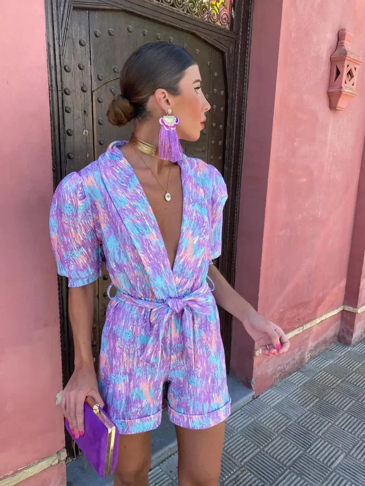 Elegant women's puff sleeve romper with belt, perfect for wedding guests or special occasions.