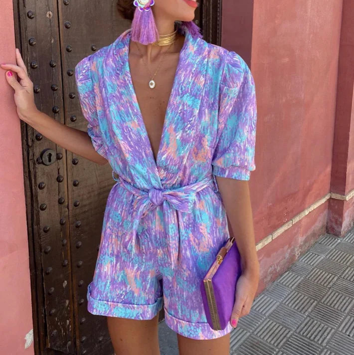 Stylish lilac puff sleeve romper for women, featuring a chic belt, ideal as a wedding guest outfit.