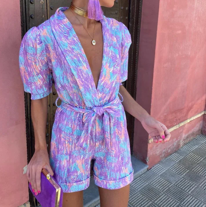 Pretty pink puff sleeve short romper with a flattering belt, great for parties and special events.