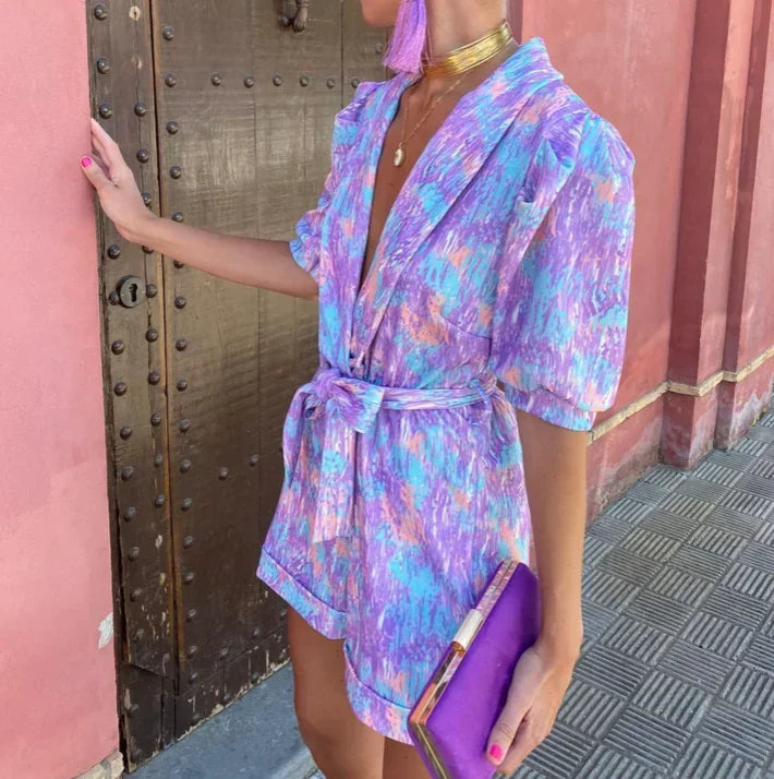 Women's belted romper with trendy puff sleeves, offering a comfortable and elegant wedding guest look.