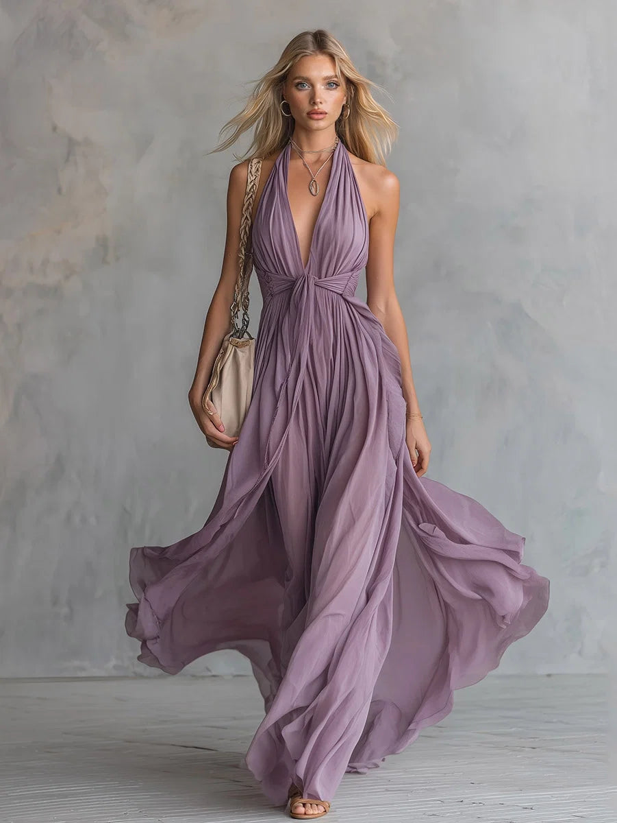 Elegant women's purple ruched halter neck flowing maxi dress, perfect for evening wear or as a wedding guest.