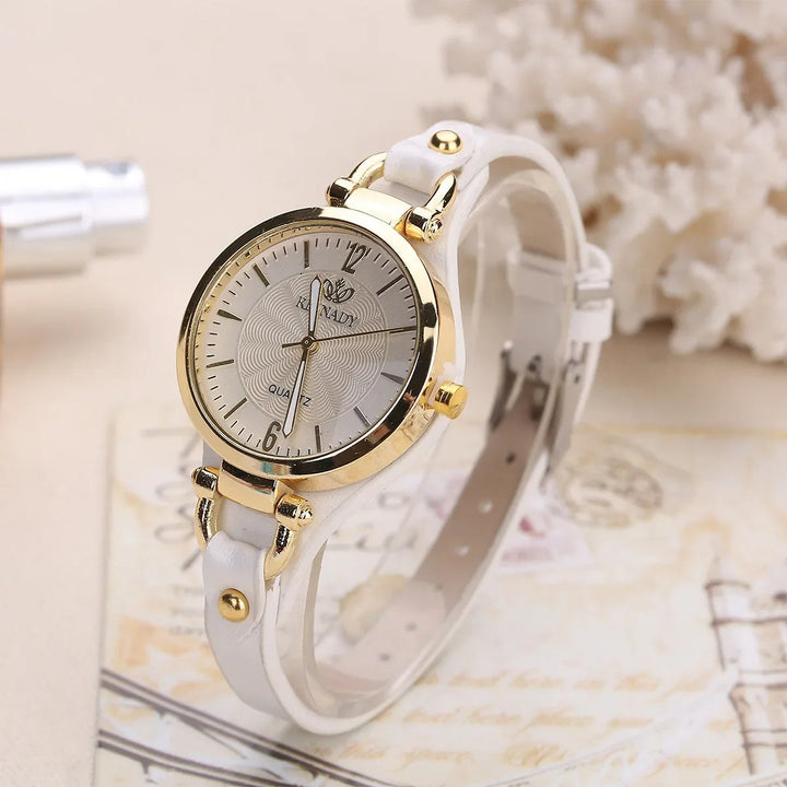 Fashionable ladies' quartz watch with intricate engraved dial and slender vegan leather wrist strap.