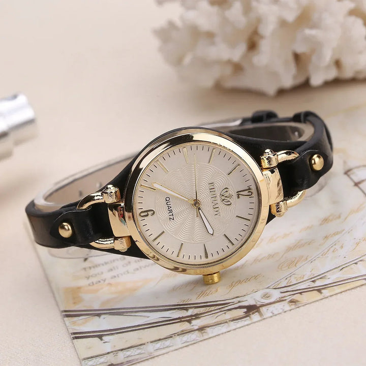 Ladies' quartz watch, detailed engraved dial, and smooth vegan leather strap for an elegant look.